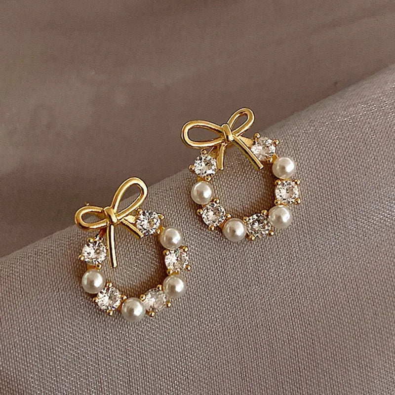 The 2025 high-quality retro and elegant earrings are diamond-encruffled bow pearl fashion earrings, suitable for the daily fresh